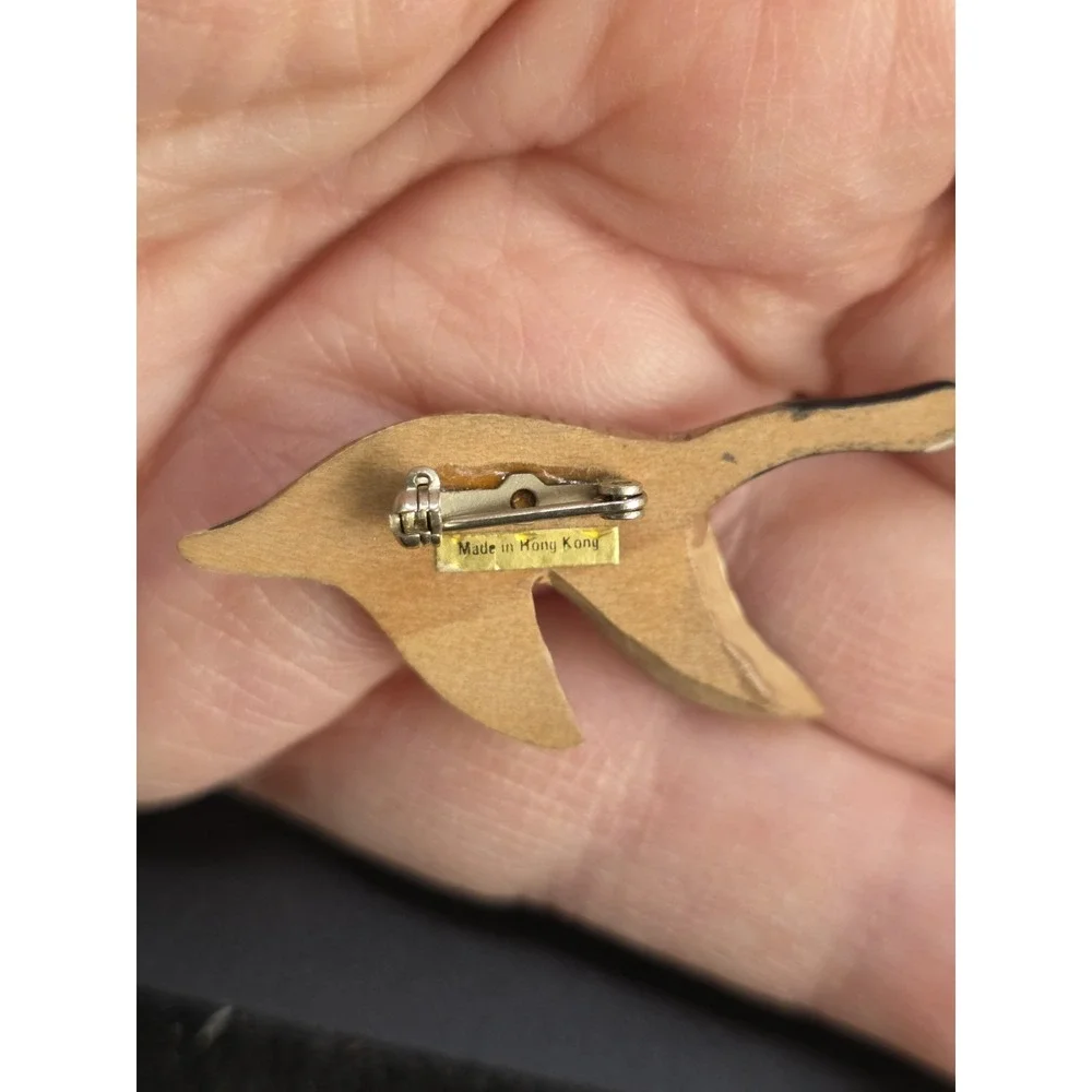 small, hand-carved and painted wooden Canada goose pin